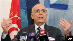 Tunisian Prime Minister Mohammed Ghannouchi gestures as he announces his resignation during a press conference in Tunis, February 27, 2011