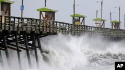 Waves kicked up by Hurricane Florence pound the Bogue Inlet Pier in Emerald Isle, N.C., Sept. 13, 2018.