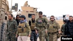 Syrian Democratic Forces and U.S. troops are seen during a patrol near Turkish border in Hasakah, Syria, Nov. 4, 2018.