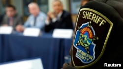 FILE - Law enforcement from Hennepin county, Minnesota takes part in a round table discussion on ways to reduce gun violence during a visit to the Minneapolis.