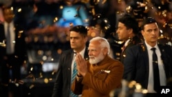 Indian Prime Minister Narendra Modi, center, greets supporters and workers as he arrives at the Bharatiya Janata Party headquarters to celebrate his party's win in Delhi state elections in New Delhi, India, on Feb. 8, 2025.