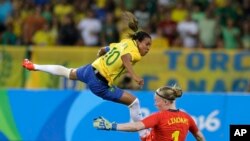 Rio Olympics Soccer Women: Brazil's Marta, left, leaps over Sweden goalkeeper Hedvig Lindahl as she attempts a shot on goal during a group E match of the women's Olympic football tournament between Sweden and Brazil at the Rio Olympic Stadium in Rio De Ja