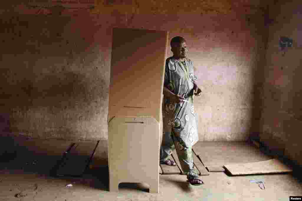 A man walks out of a voting booth during the second round of presidential elections, Bamako, August 11, 2013. 
