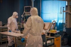 Medical staff tends to a patient in the ICU unit of Rome's San Filippo Neri Hospital's Covid department, in Rome, April 9, 2020.