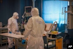 Medical staff tends to a patient in the ICU unit of Rome's San Filippo Neri Hospital's Covid department, in Rome, April 9, 2020.