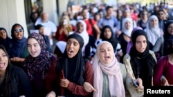FILE - Students chant while marching at a rally against Islamophobia at San Diego State University in San Diego, California, Nov. 23, 2015.
