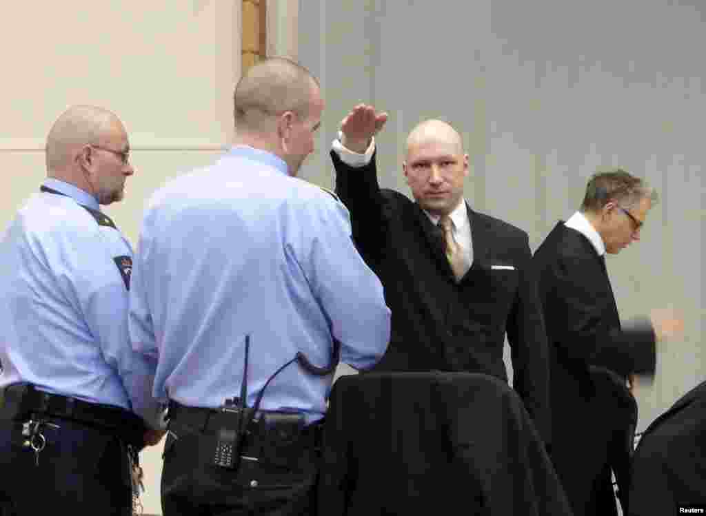 Norwegian mass killer Anders Behring Breivik raises his arm in the Nazi salute as he enters the court room in the Skien prison.