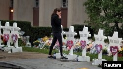 A woman reacts at a makeshift memorial outside the Tree of Life synagogue following Saturday's shooting at the synagogue in Pittsburgh, Oct. 29, 2018. 
