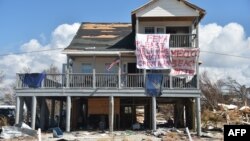 A sign that reads "FEMA please help make Mexico Beach great again" is seen on a damaged house by Hurricane Michael in Mexico Beach, Florida, on Oct. 15, 2018. 