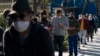 FILE - People wait in line for a COVID-19 test in Los Angeles, Jan. 4, 2022. 