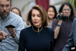 Speaker of the House Nancy Pelosi, D-Calif., walks with reporters to a Democratic Caucus meeting the morning after President Donald Trump's State of the Union speech, on Capitol Hill in Washington, Feb. 6, 2019.