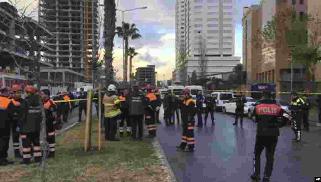 Emergency services stand at the scene of an explosion, in Izmir, Turkey, Jan. 5, 2017.