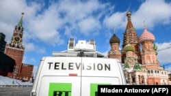 RUSSIA -- A Russia's state-controlled Russia Today (RT) television broadcast van is seen parked in front of St. Basil's Cathedral and the Kremlin next to Red Square in Moscow, March 16, 2018