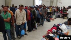 Central American migrants gather before continuing their journey to the U.S. despite President Donald Trump's vow to stamp out illegal immigration, in Ixtepec, Oaxaca, Mexico, March 31, 2018.