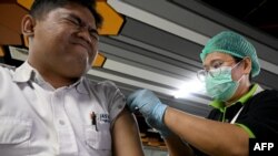 A man receives the Inavac Covid-19 coronavirus booster vaccine for airport workers at Ngurah Rai Airport near Denpasar on the Indonesian resort island of Bali on December 29, 2023.