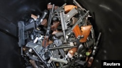 Hand guns turned in by their owners lie in a trash bin in Los Angeles. The Los Angeles Police Department held a buy-back to get guns off the street. The program to buy guns followed the mass shooting at Sandy Hook Elementary School in Connecticut on December 26, 2012.