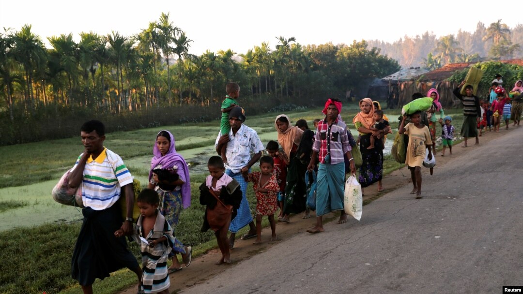 A group of Rohingya refugees, who fled last night from Myanmar by boat, walks toward a makeshift camp in Cox's Bazar, Bangladesh, Nov. 9, 2017.