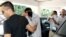 Police escort two of three British tourists suspected of stabbing an off-duty British solider to a court in Paralimni, November 5, 2012.