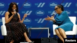 FILE - First lady Michelle Obama and television presenter Oprah Winfrey participate in the White House's "United State of Women" summit in Washington, June 14, 2016.