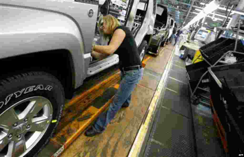 FILE - In this Nov. 16, 2011 file photo, Pam Bialecki works on a 2012 Jeep Wrangler at the Chrysler Toledo Assembly complex, in Toledo, Ohio. Chrysler says it will add 1,100 jobs at the assembly complex as part of a $1.7 billion investment to build a new 