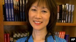 FILE - In this Nov. 5, 2002 file photo, Tess Gerritsen, an author and one of the biggest names in the medical thriller genre, stands in the library at her home in Camden, Maine.