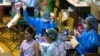 A health worker administers a dose of the Sinovac COVID-19 vaccine to a woman at Thai-Japan Bangkok Youth Center in Bangkok, Thailand, June 14, 2021.