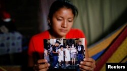 Norma Méndez, esposa del migrante salvadoreño Marvin González, quien murió en un centro de detención en Nuevo México, muestra fotos de Marvin en su casa de Verapaz, El Salvador, el 2 de agosto de 2019. REUTERS/José Cabezas.