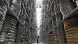 Kirsty Shanks, Film Conservation Specialist at British Film Institute, poses for a photograph whilst looking at a film can in the storage archives at the British Film Institute (BFI) in Berkhampsted, north of London, Oct. 3, 2024. 