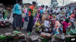 Ethiopians from different towns in the Amhara region wait for food to be distributed at lunchtime at a center for the internally displaced in Debark, in the Amhara region of northern Ethiopia, Aug. 27, 2021.