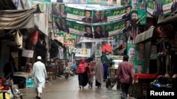 A street is decorated with the flags and banners of political parties ahead of a general election in Rawalpindi, Pakistan, July 23, 2018.