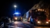 Police officers and rescuers work the scene of a bus accident in Porte-Puymorens, southern France, Dec. 1, 2024.