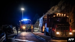 Police officers and rescuers work the scene of a bus accident in Porte-Puymorens, southern France, Dec. 1, 2024.