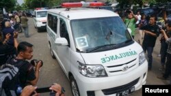 In this photo taken by Antara Foto, ambulances carrying coffins make their way to Nusa Kambangan prison at Wijayapura quay, Cilacap, Central Java, Indonesia, Jan. 17, 2015.