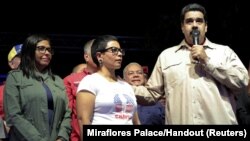 Venezuela's President Nicolas Maduro (R) speaks during an event with supporters, next to newly elected mayor of Libertador district Erika Farias (C) and President of Venezuela's National Constituent Assembly Delcy Rodriguez (L), in Caracas, Venezuela, Dec