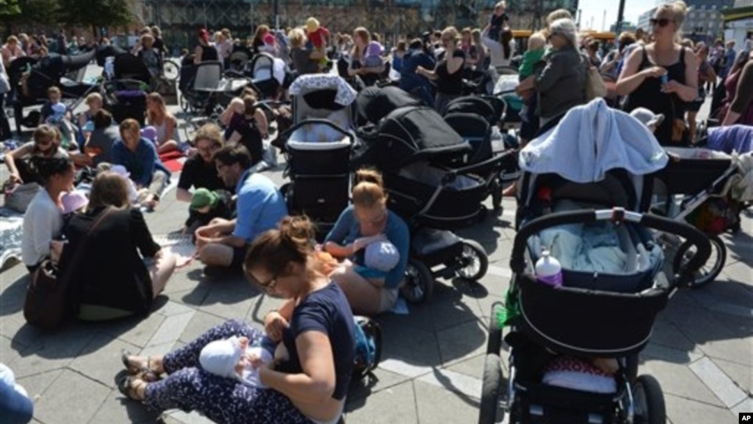 Hundreds of women promote public breastfeeding outside City Hall Square, Copenhagen, June 17, 2013.