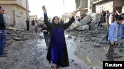 A woman reacts near the site of a car bomb attack in Kirkuk, 250 km (155 miles) north of Baghdad, November 14, 2012.