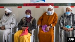 FILE - Moroccans wait their turn for the COVID-19 vaccine at an inoculation center in the city of Sale on February 12, 2021, as part of a campaign in the region.
