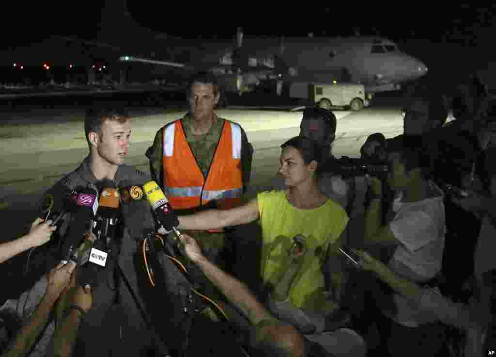 Pilot Angkatan Udara Australia Kapten Russell Adams (kiri) berbicara pada media setelah kembali dari misi pencarian dalam pesawat AP-3C Orion di Pangkalan AU Pearce di Perth (23/3). (AP/Matt Jelonek)