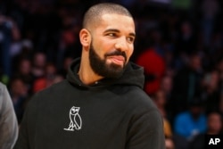 FILE - Drake attends an NBA game.