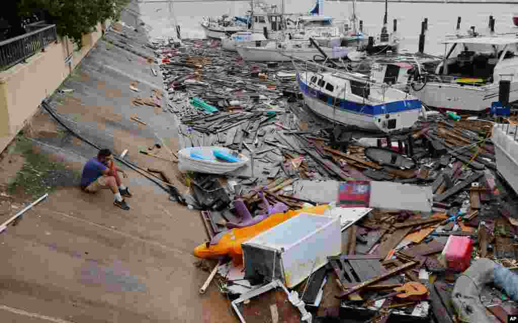Allen Heath surveys the damage to a private marina after it was hit by Hurricane Hanna in Corpus Christi, Texas.