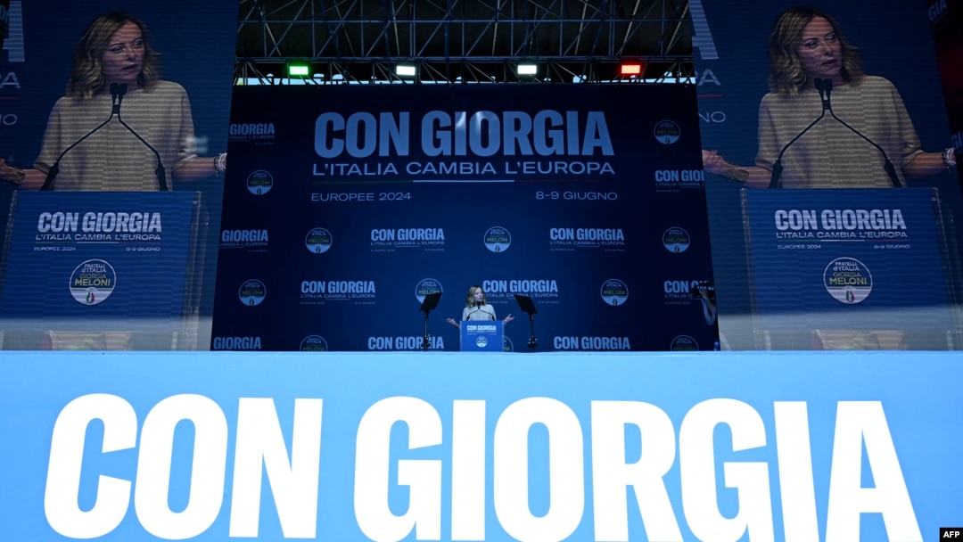 Italian Prime Minister Giorgia Meloni delivers a speech during a campaign meeting of Italian far-right party Brothers of Italy for the upcoming European elections, on June 1, 2024, in Rome. The banner behind her reads "With Giorgia, Italy changes Europe."