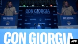 Italian Prime Minister Giorgia Meloni delivers a speech during a campaign meeting of Italian far-right party Brothers of Italy for the upcoming European elections, on June 1, 2024, in Rome. The banner behind her reads "With Giorgia, Italy changes Europe."