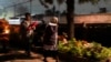 Women arrive at the cemetery to keep company with departed loved ones as they celebrate Day of the Dead at the San Gregorio Atlapulco on the outskirts of Mexico City, Nov. 1, 2024. 