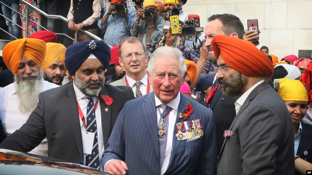 FILE - Britain's Prince Charles, center, prepares to leave after visiting Gurudwara Bangla Sahib, a Sikh Temple in New Delhi, India, Nov. 13, 2019.