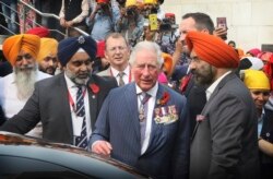 Britain's Prince Charles, center, prepares to leave after visiting Gurudwara Bangla Sahib, a Sikh Temple in New Delhi, India, Nov. 13, 2019.