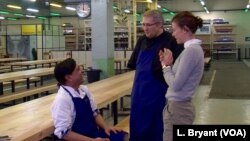 Chefs Keshar Sharma (L) and Nabil Attar (C) chat with Marine Mandrila, co-founder of the Refugee Food Festival and La Residence restaurant.