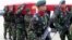 Indonesian soldiers carry the coffins of their colleagues who were killed in a clash with separatist rebels in Papua province upon arrival at Juanda airport in Surabaya, East Java, Indonesia, Tuesday, April 11, 2006.