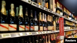 FILE - Bottles of Champagne are displayed for sale in a supermarket in Vertou, near Nantes, France, June 20, 2017. 