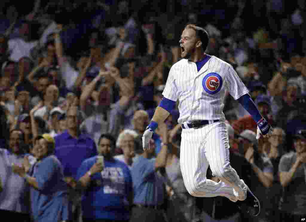 Chicago Cubs' David Bote reacts as he rounds the bases after hitting the game-winning grand slam against the Washington Nationals during the ninth inning of a baseball game in Chicago, Illinois, Aug. 12, 2018.