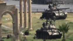 In this image made from amateur video released by the so-called Shams News Network, a loosely organized anti-Assad group and accessed via The Associated Press Television News on Aug. 1, 2011, military armored vehicles are seen in the central city of Hama,